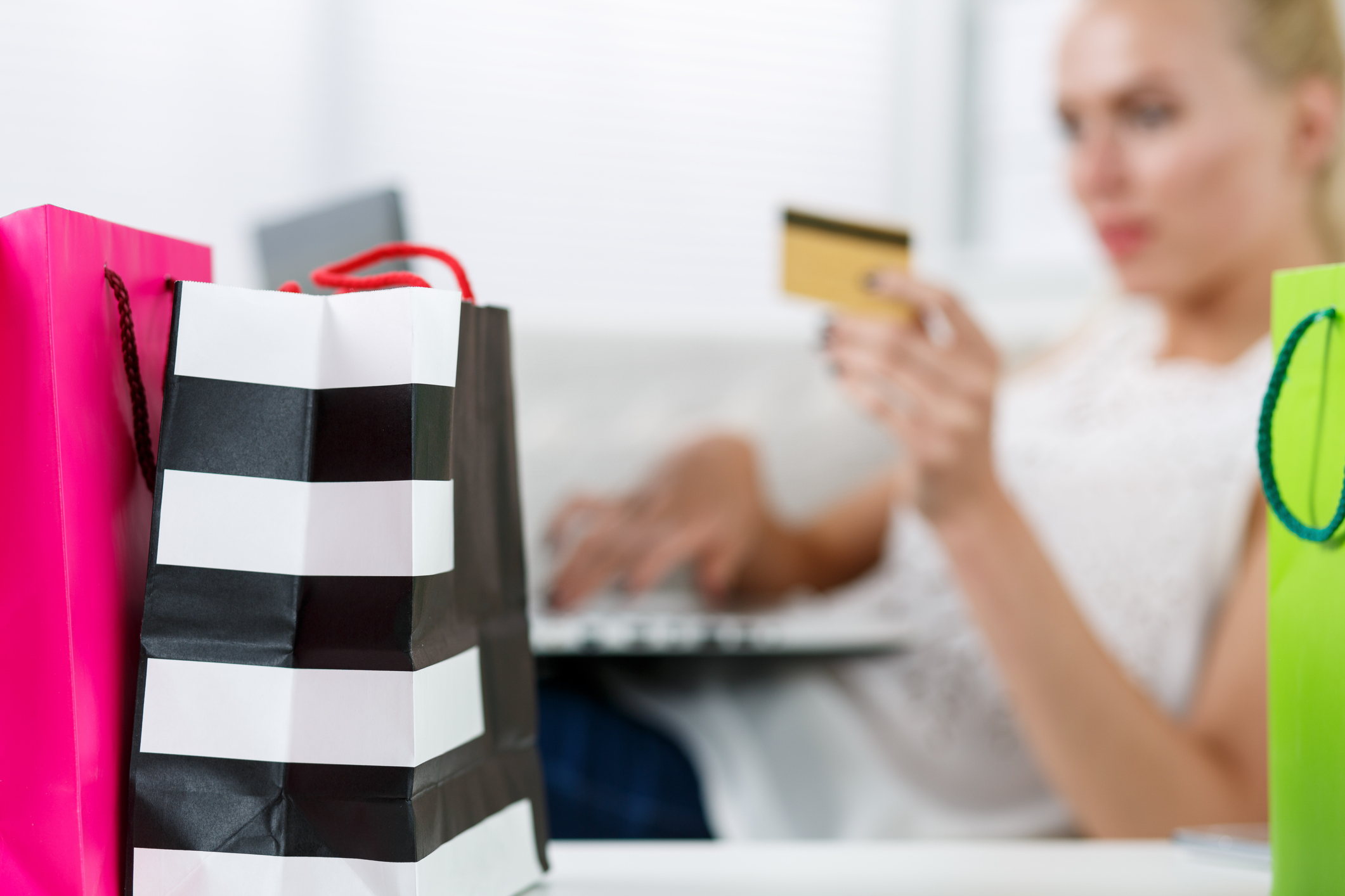 Blond woman making purchasing via internet paying credit card