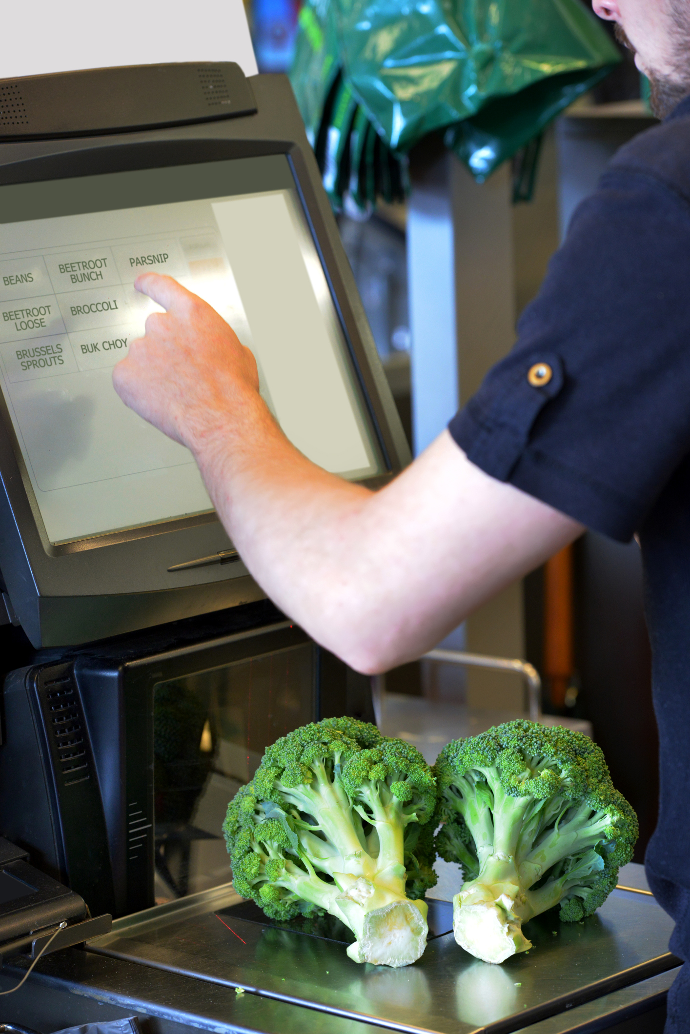 Young man at self check out counter at a supermarket